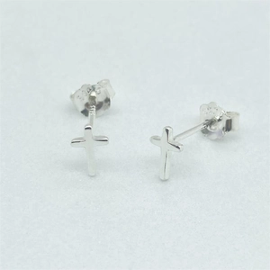 Close-up of S925 sterling silver cross studs showing the hallmark and fine metal texture