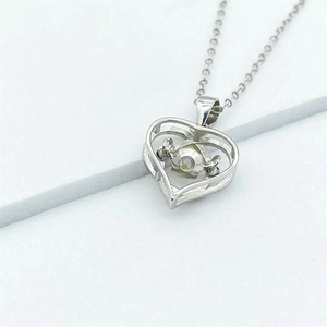 Detailed close-up of a S925 sterling silver heart pendant with a dancing stone center