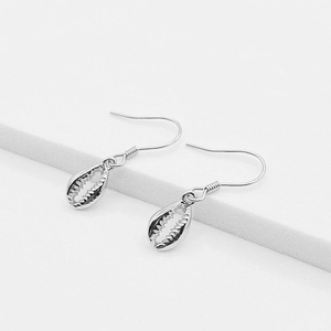 Minimalist S925 sterling silver shell drop earrings on a clean white geometric background