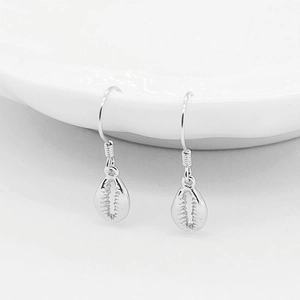 S925 sterling silver seashell drop earrings with minimalist hook design on white ceramic