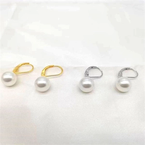 Detail of gold and silver S925 sterling silver leverback earrings with white shell pearls