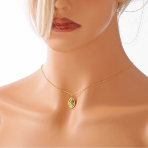 Detail of gold S925 sterling silver Virgin Mary medallion necklace on model neck