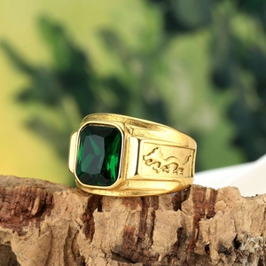 Vintage men's gold titanium ring featuring an emerald-green gemstone and dragon relief