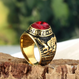 Detailed close-up of a vintage gold eagle ring featuring a large faceted red gemstone