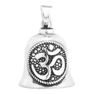 Macro view of vintage silver steel bell pendant with Om symbol and hammered texture