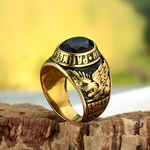 Macro view of vintage gold eagle signet ring with a large faceted black gemstone
