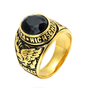 Close-up of golden eagle high school ring featuring a faceted black gemstone and relief