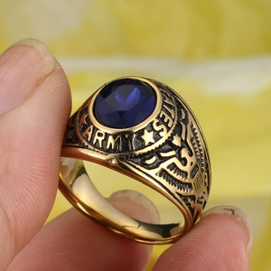 Vintage gold military ring for men featuring a blue sapphire gem and eagle relief
