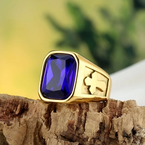 Vintage golden stainless steel men's ring with a large blue gemstone and cross motif