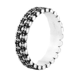 Detail of vintage gothic skull ring with black oxidized finish and relief carvings