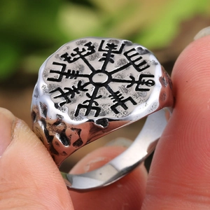 Detailed close-up of a vintage Viking compass signet ring with rustic black finish
