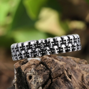 Gothic punk style double-row skull ring in vintage stainless steel on rustic wood