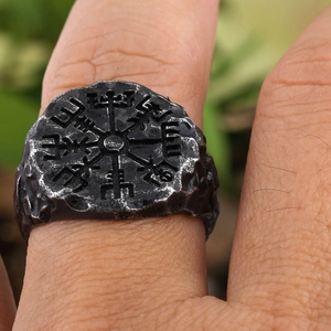 Macro shot of vintage Viking Vegvisir compass ring with aged finish and hammered texture