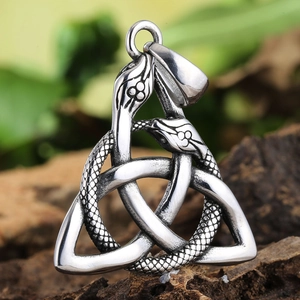 Macro view of vintage Celtic knot serpent pendant with detailed snake scale textures