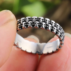 Retro punk stainless steel wide ring featuring three rows of 3D skull head reliefs