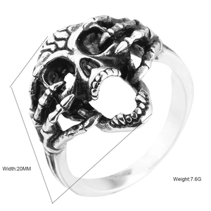 Gothic skull ring in antique silver finish with skeletal hand design, 20mm width