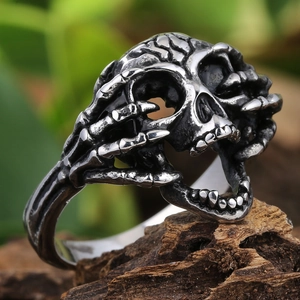 Gothic skull ring in polished 304 stainless steel with oxidized finish on wood background
