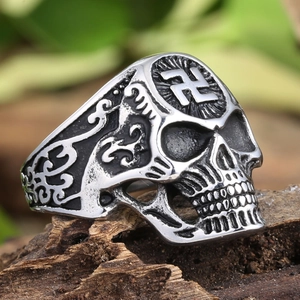 Detailed macro view of retro skull ring in stainless steel with swastika and carvings