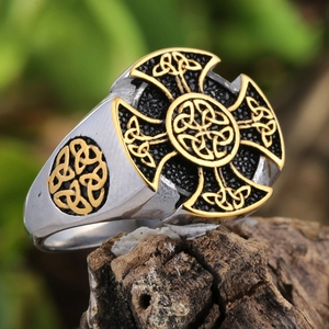 Men's vintage silver stainless steel Viking ring with golden Celtic cross on wood