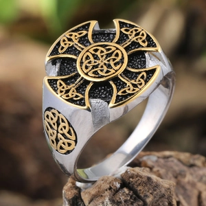 Vintage Celtic Knot cross ring in silver and gold stainless steel on wooden base