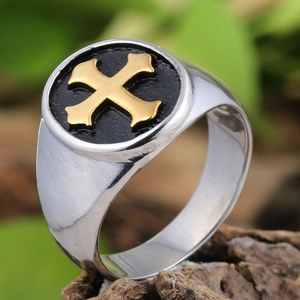 Vintage silver signet ring for men with a gold cross emblem on black background
