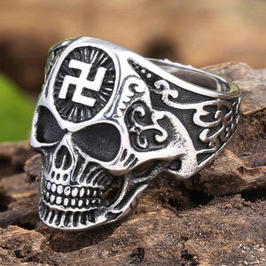 Macro detail of punk skull ring in stainless steel with engraved swastika symbol