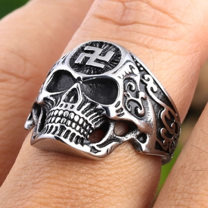 Macro shot of vintage skull ring with swastika engraving and gothic steel details