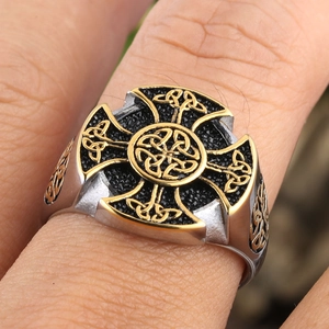 Close-up of vintage Celtic knot cross ring featuring silver and gold dual-tone detailing