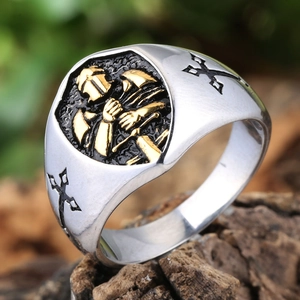 Detailed macro view of vintage silver knight ring featuring a gold warrior shield and crosses