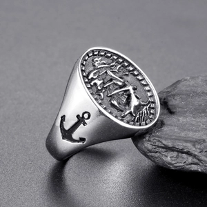 Vintage men's stainless steel signet ring featuring sailboat relief and anchor side detail