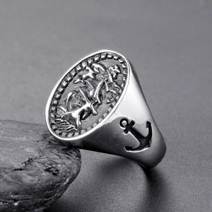 Macro shot of stainless steel signet ring featuring detailed anchor engraving on side