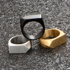 Three-piece set of geometric stainless steel rings in black, silver, and gold matte finishes