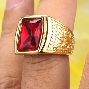 Detailed close-up of a vintage gold signet ring featuring a large rectangular red gemstone
