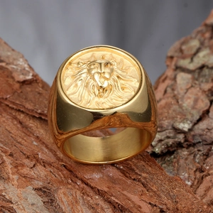 Detailed relief of a golden lion head on a vintage style men's stainless steel signet ring