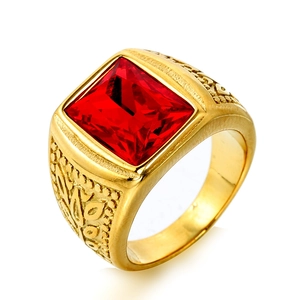 Detailed view of vintage gold ring with square red gemstone and embossed side patterns
