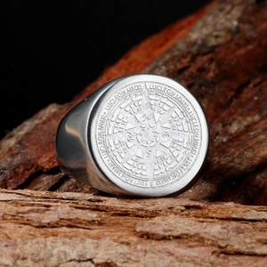 Macro detail of stainless steel compass ring showing deep engraved nautical patterns