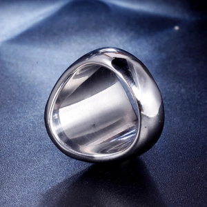 Macro shot of heavy silver stainless steel wide ring with high polished mirror finish