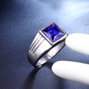 Macro shot of men's titanium steel ring with square blue gemstone and side groove detailing
