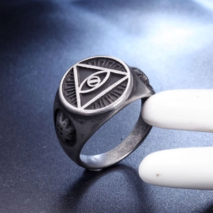 Macro shot of retro stainless steel ring featuring engraved All-Seeing Eye and gothic details
