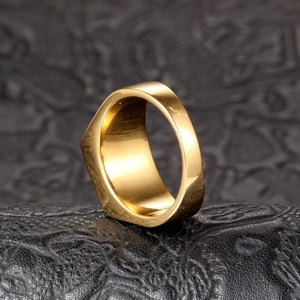 Macro view of a polished gold signet ring with a thick geometric band on black leather
