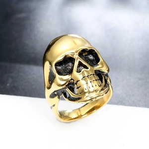 Detailed close-up of gold stainless steel skull ring with vintage punk texture