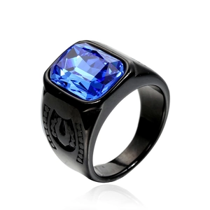 Detail of men's black punk ring with blue rectangle gemstone and horseshoe carving