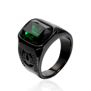 Detail of a men's black plated ring featuring a large emerald cut green gemstone