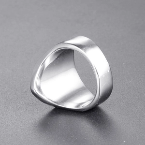 Close-up of a thick silver stainless steel ring with a polished triangular design