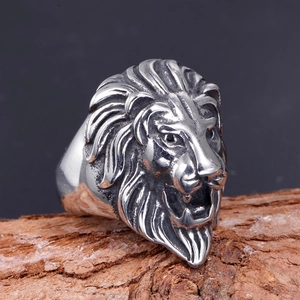 Detailed macro of vintage stainless steel lion head ring showing intricate carved textures