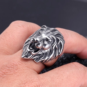 Macro shot of detailed lion head engraving on a vintage silver stainless steel ring