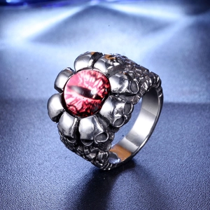 Macro view of gothic skull ring with vintage silver finish and red reptile eye gemstone
