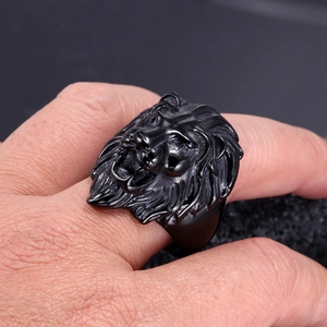 Macro shot of men's matte black stainless steel lion head ring with 3D carving details