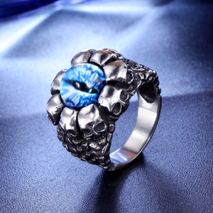 Macro detail of gothic skull ring with a blue dragon eye stone and retro silver finish