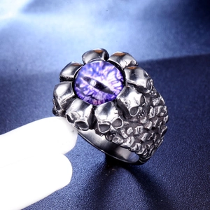 Detailed close-up of retro punk titanium steel ring with purple eye and skull design